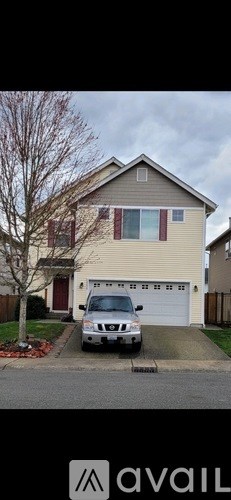 A house with a car parked in front.