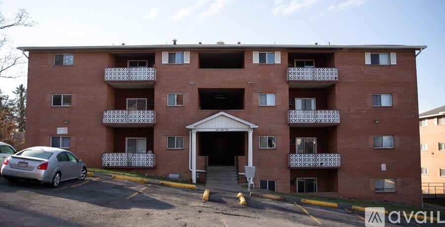 A large red brick building with a car parked in front.