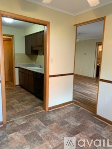 A room with a kitchen area and a bathroom.