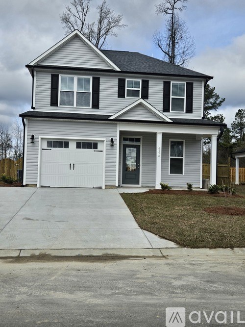 A two-story house with a garage is available for sale.
