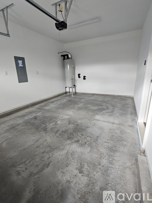 A room with a concrete floor and white walls.