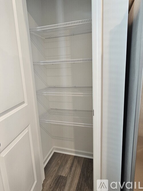Empty white shelves in a refrigerator.