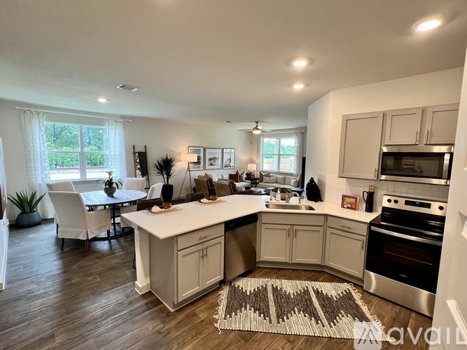 A kitchen with a dining table and chairs is shown.
