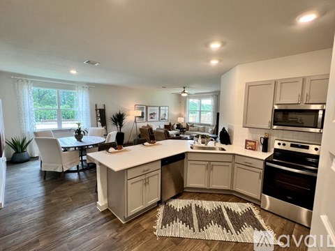 A kitchen with a dining table and chairs is shown.