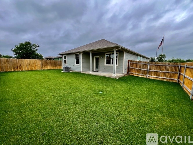 A house with a grey roof and a green lawn.