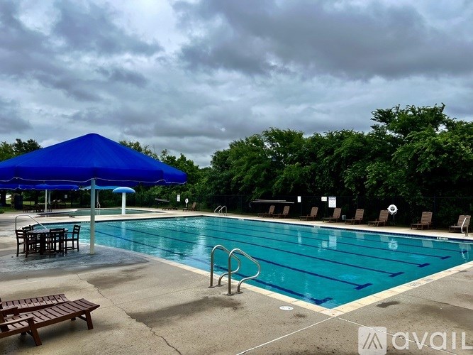 A pool with a blue canopy and a bench.