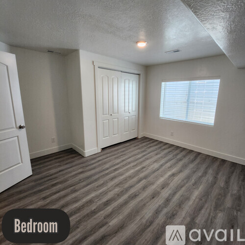 A bedroom with a door and a window.