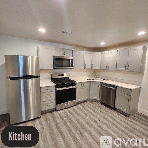 A kitchen with white cabinets and stainless steel appliances.