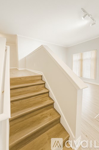 A staircase with wooden steps and white railings.