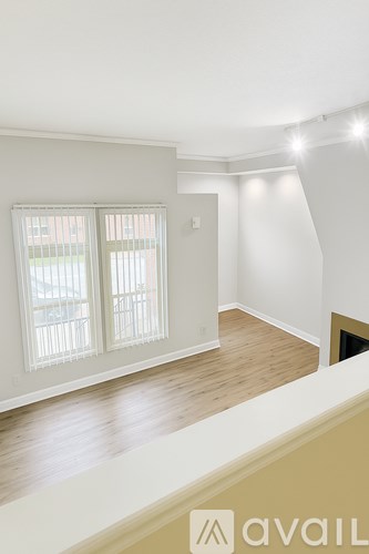 A room with a window and a door is available for rent.