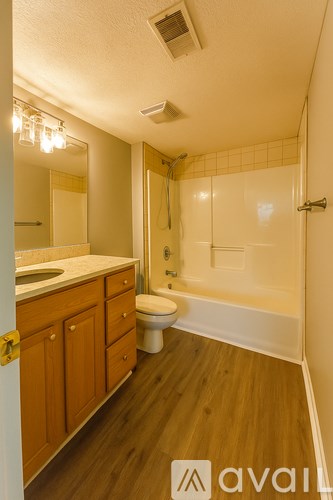 A bathroom with a toilet, sink, and bathtub.