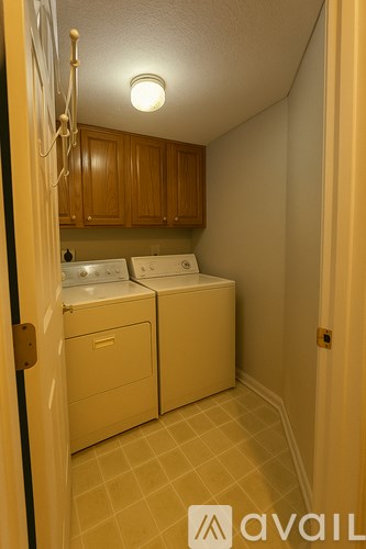A small laundry room with a washer and dryer.