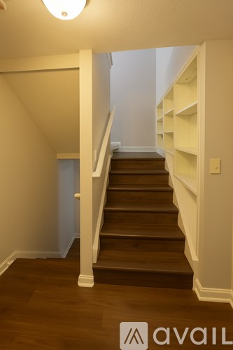 A staircase with a white railing and wooden steps.