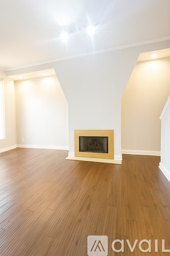 A room with a fireplace and wooden floors.