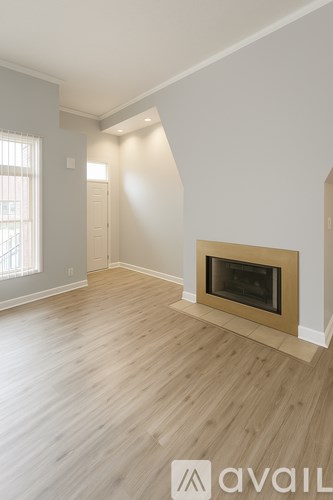 A room with a fireplace and wooden floors.