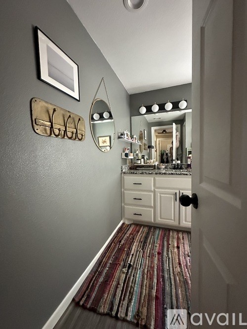 A hallway with a mirror and lights above it.