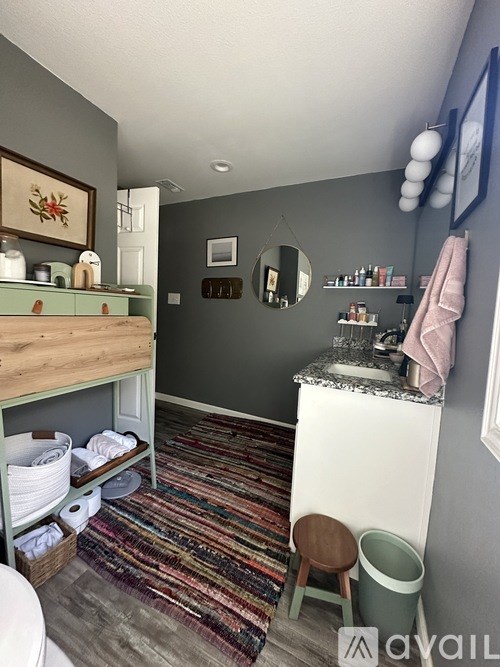 A bathroom with a white toilet and a wooden stool.