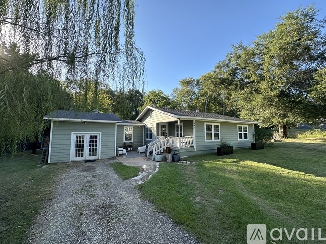 A house with a gravel driveway in front of it.