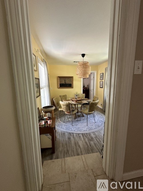 A dining room with a round table and chairs.