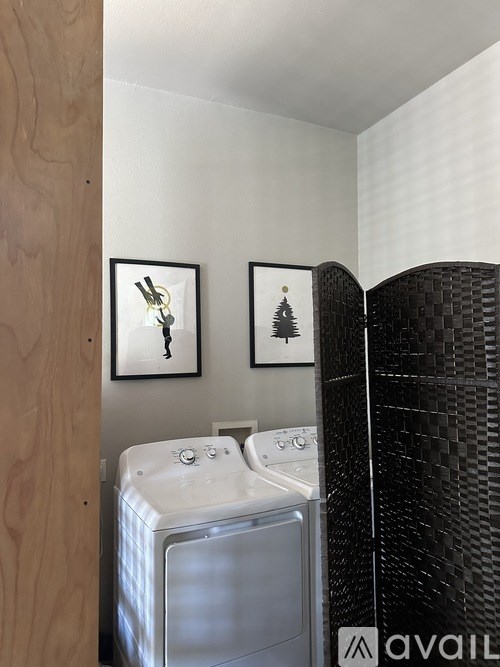 A washing machine is in a small laundry room.