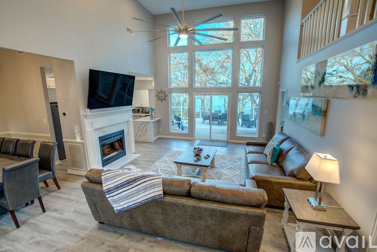 A living room with a fireplace and a television.