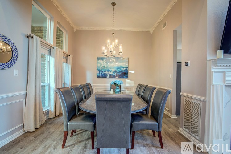 A dining room with a table and chairs.