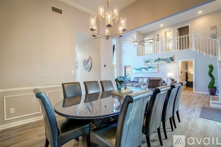 A dining room with a table and chairs.