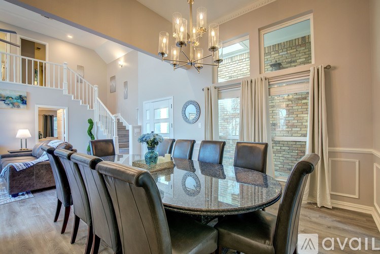 A dining room with a table set for four.