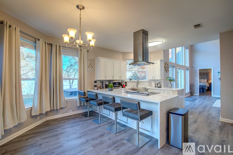 A modern kitchen with a large island and a dining area.