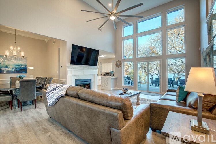 A living room with a couch, a fireplace, and a television.