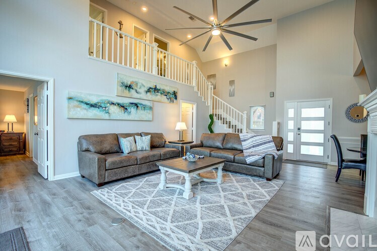 A living room with a couch, a coffee table, and a painting on the wall.