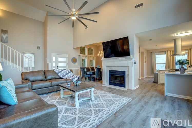A living room with a fireplace and a television.