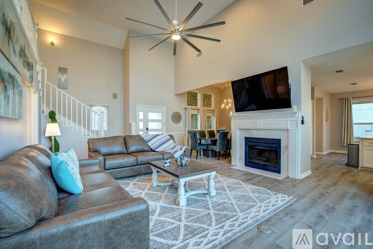 A living room with a grey couch and a white coffee table.