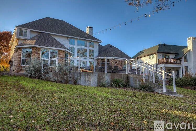 A house with a large front yard and a deck.