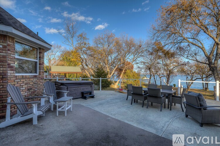 A patio with chairs and a hot tub is available for rent.