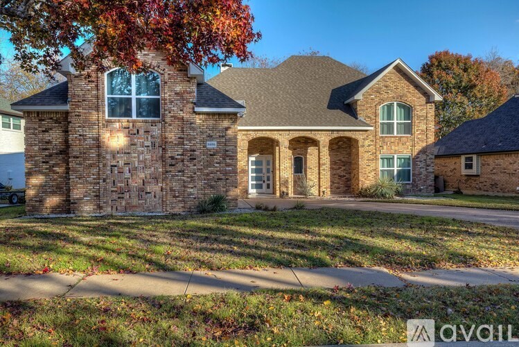A house with a stone facade and a large front yard.
