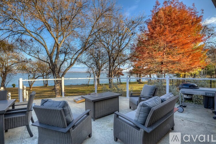 A patio with outdoor furniture and trees.