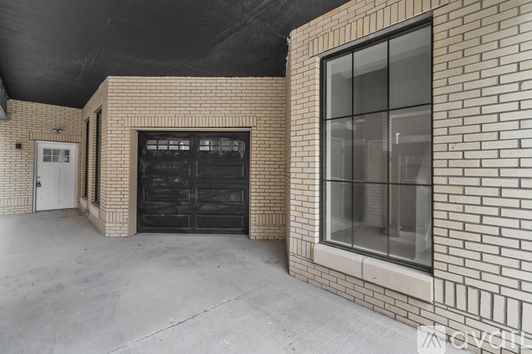 A garage door is open in a brick building.
