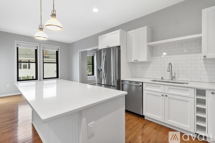 A modern kitchen with white cabinets and a large island.