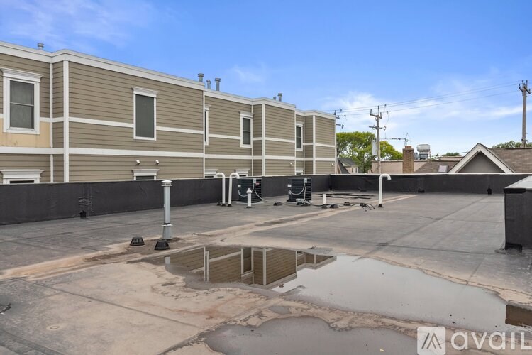 A parking lot in front of a building with a sign that says "available".