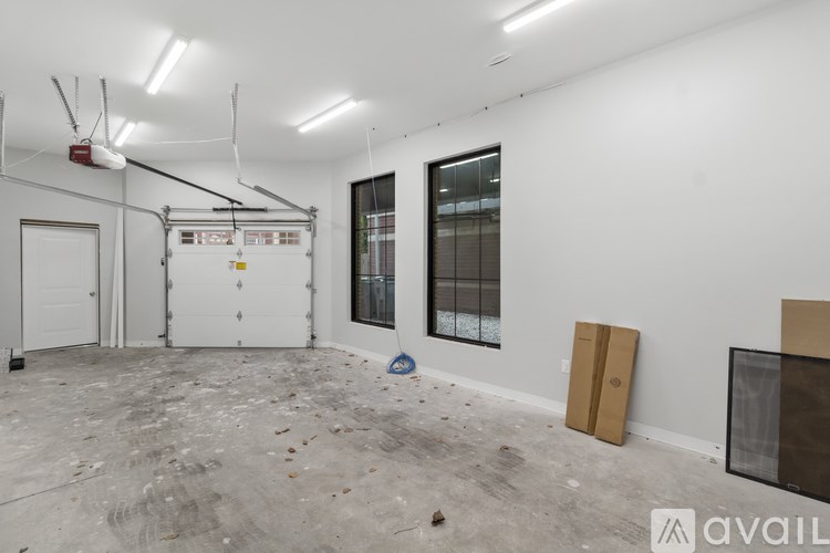 A room with white walls and a concrete floor is shown.