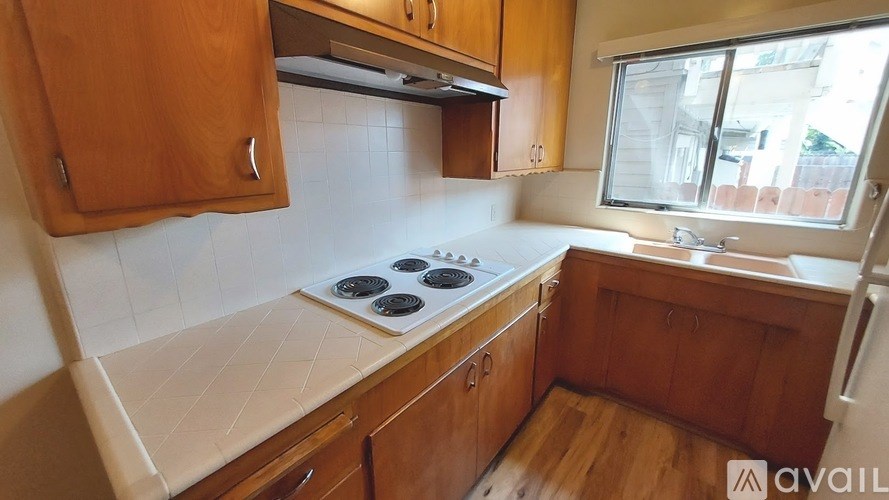 A kitchen with wooden cabinets and a white countertop.