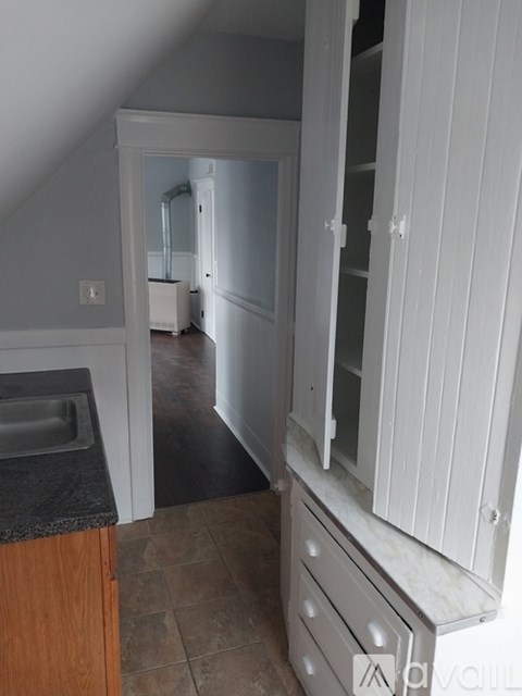 A kitchen with a sink and a cabinet.