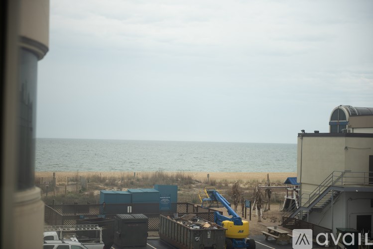 A construction site is visible from a window overlooking the beach.