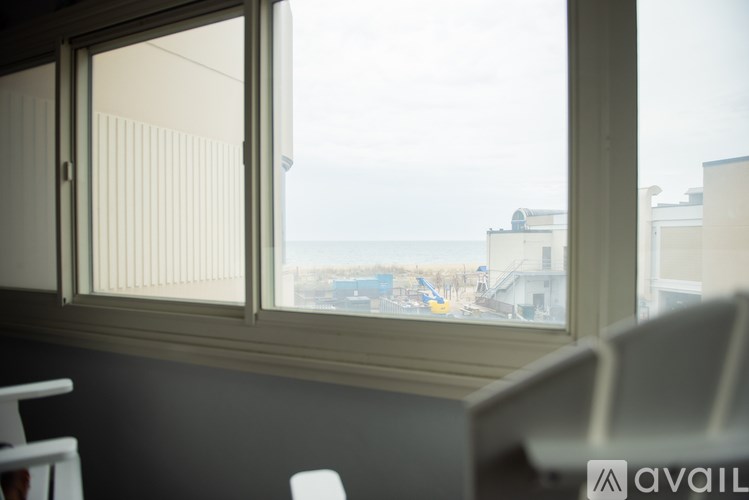 A window with blinds overlooking a construction site.