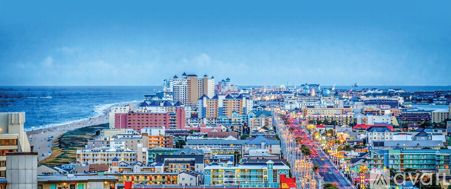 A cityscape with buildings and a beach in the background.
