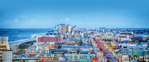 A cityscape with buildings and a beach in the background.