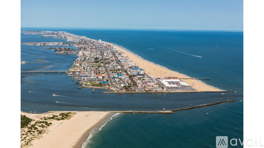 A beachfront city with a long pier extending into the water.