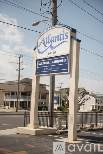 A sign for Atlantis 10300 Coldwell Banker Vacations stands in front of a building.