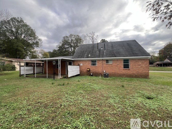 A house with a grey roof and a white garage door.